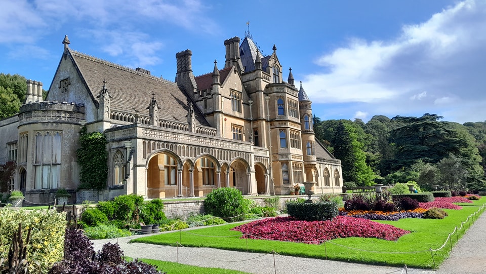 The exterior of the Tyntesfield House National Trust property with its immaculate gardens in the foreground